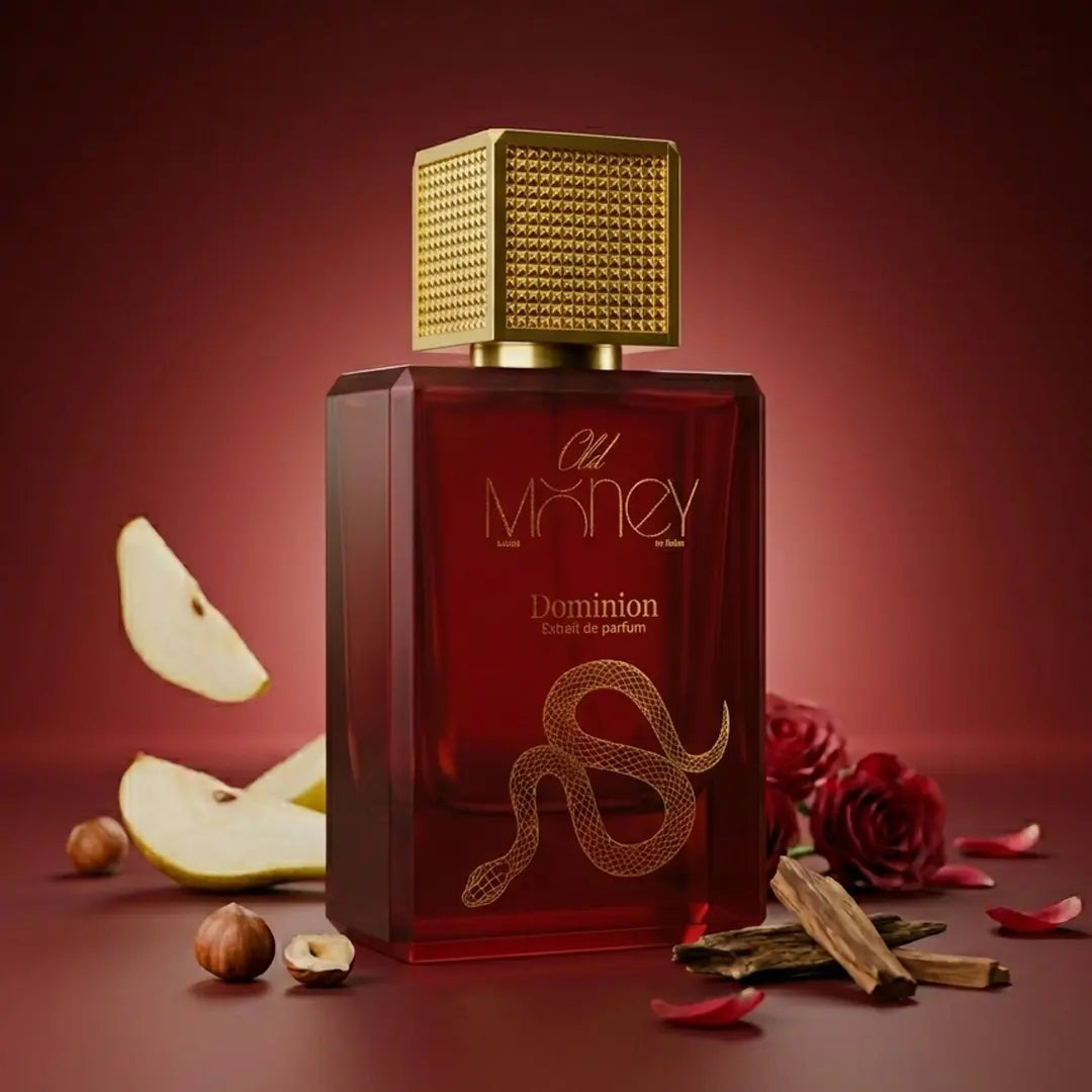 Old Money Dominion Extrait de Parfum with fresh pear slices, hazelnuts, dark red rose and oud wood chips on a rich burgundy background